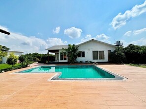 Outdoor pool, open 3:00 PM to midnight, pool umbrellas