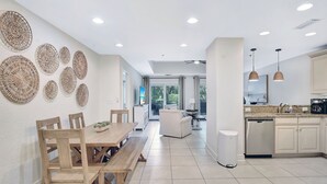 A modern kitchen with white cabinets, a dishwasher, and pendant lights. - Located in the heart of the south end.  Close to everything (Saint Simons Island)