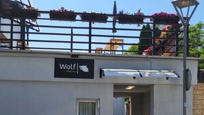 A building with a sign reading "Wolf Family Inn". - Pension Wolf (Hohe Börde)