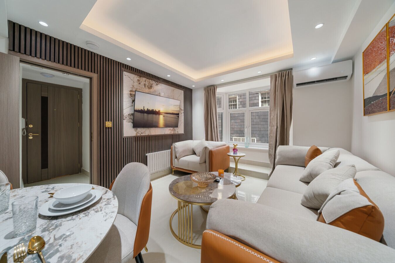 A modern living room with a sofa set, a dining table with plates and cutlery, a coffee table, and a large window with curtains.