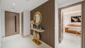 A modern hallway with a console table, a mirror, and a decorative vase.