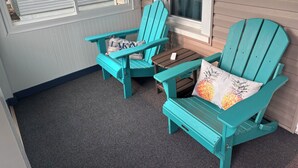 A small outdoor seating area with two turquoise Adirondack chairs and a small table. - 3BR, 4-Bed Home in Port Clinton (Port Clinton)