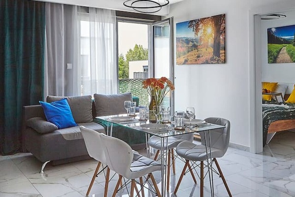 Living room with dining table and sofa bed - book now with Rentujemy.com