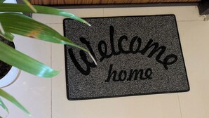 A welcome mat with the words "Welcome home" on a wooden floor.