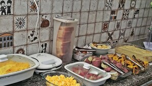 A buffet with various dishes including scrambled eggs, roasted potatoes, and a casserole dish. - 🏡 Roots Inn of Porto! Always ready to welcome you with affection💛📍 (Porto de Galinhas Ipojuca)