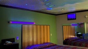 A hotel room with two beds, a television, and a ceiling with a starry design. - Dream Inn (Inglewood)
