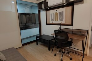 A small office space with a desk, chair, and a large window. - Oceana Suites Morandé (Santiago)