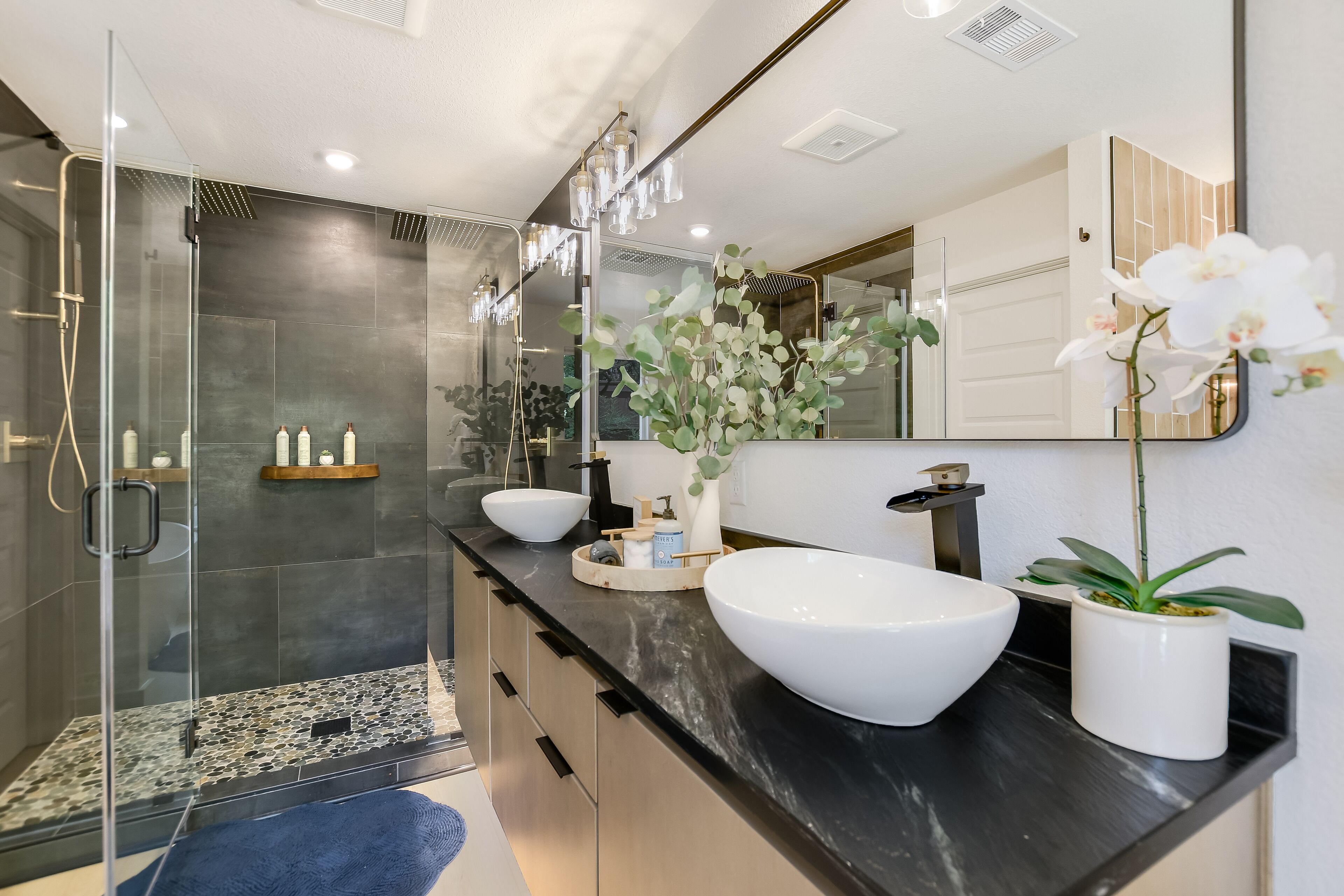 His and hers floating vanity with dual rain shower. 