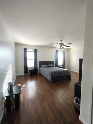 A bedroom with a bed, a ceiling fan, and a window with curtains. - Buckeye 4 bedrooms 2.5 bath browny home near freeway. (Buckeye)