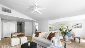 A modern living room with a sofa, coffee table, and a foosball table. - Perfect for Families & Pets, Garage Parking, Stylish Renovation, Sleeps 10 (Boise)