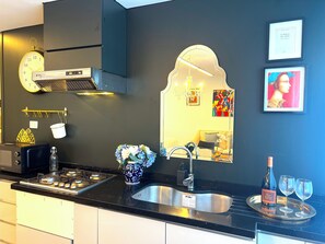 Fridge, microwave, stovetop, coffee/tea maker