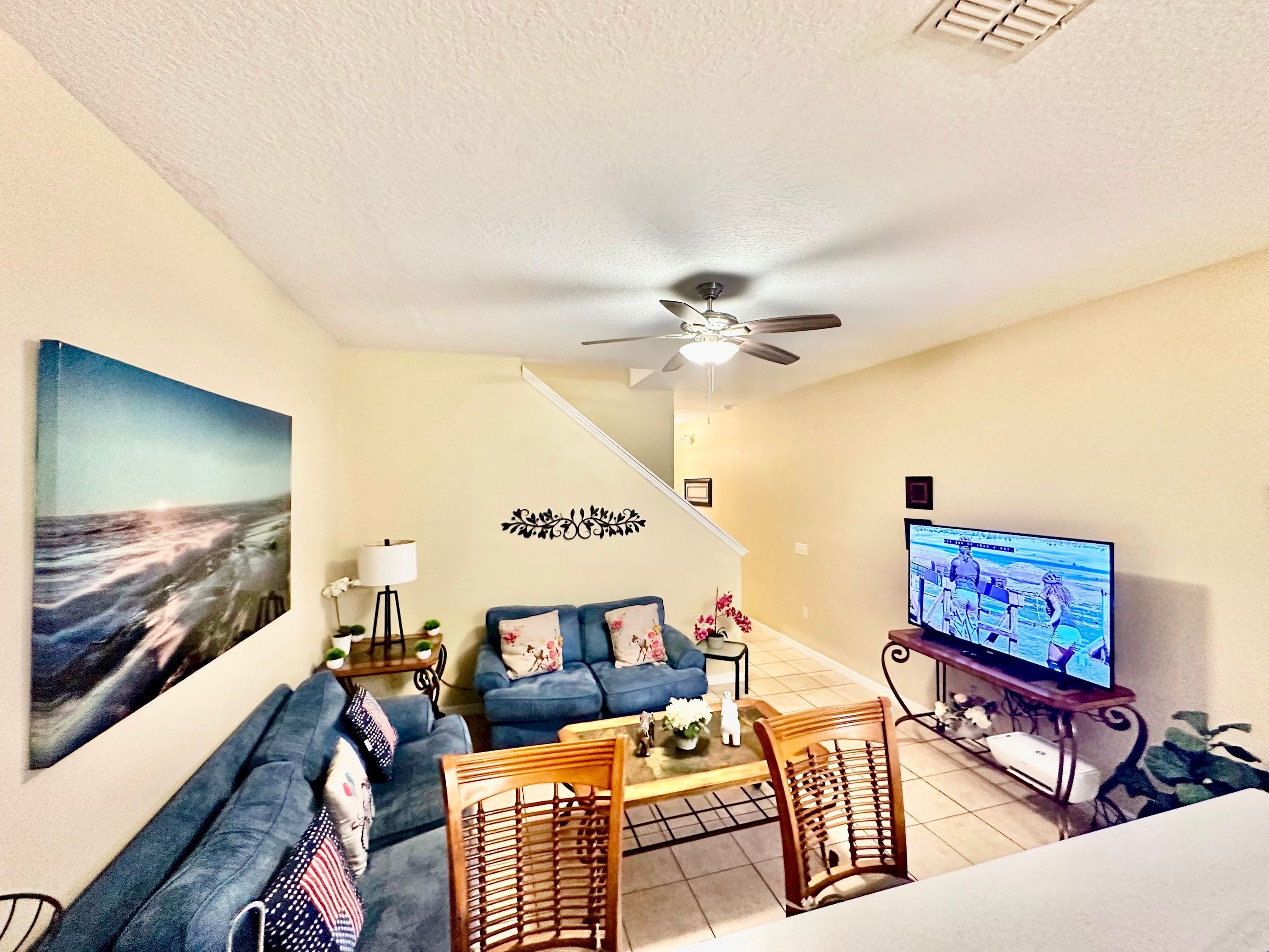 A living room with a sofa, coffee table, and a television.