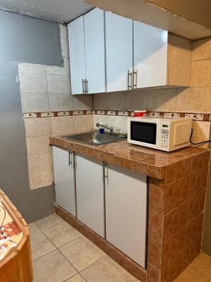 Fridge, microwave, coffee/tea maker, cookware/dishes/utensils