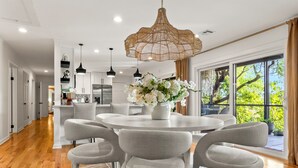 A modern kitchen with white cabinets, a central island, and pendant lighting. - *NEW* Waterfront Treehouse - Sweeping Views on 2.5 Acres (Knoxville)