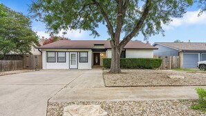 A residential house with a driveway, a tree, and a gravel area. - Austin Escape w/ Pool, Hot Tub & Game Room – DT ,Bars, South Congress, Airport ! (Austin)