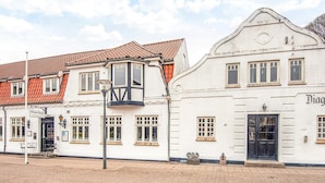 A building with a traditional facade, a sign reading 'Diagonal Room,' and a cobblestone street. - 3 Person Holiday Park Home in Give (Give)