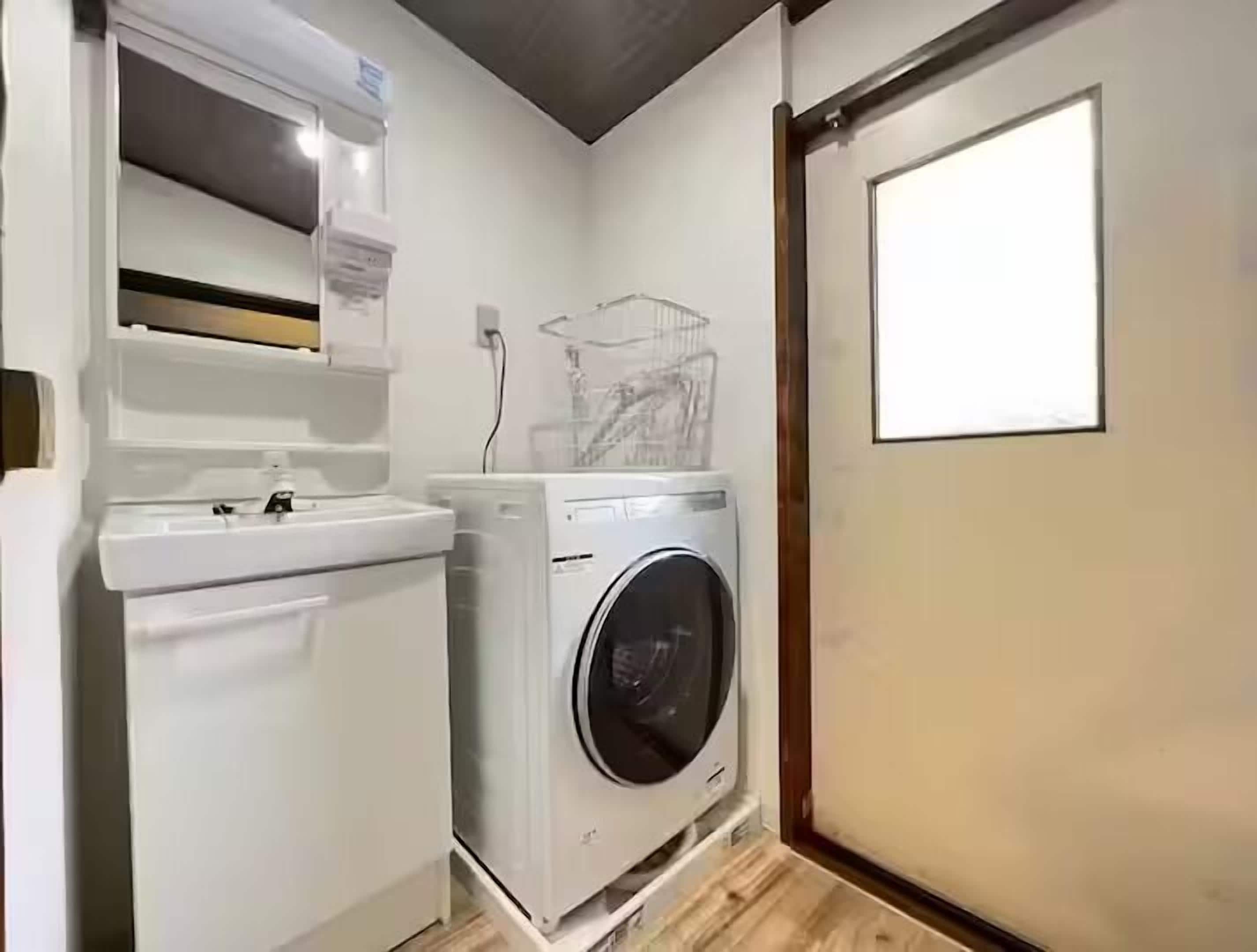 A compact laundry room with a washing machine and a dryer.