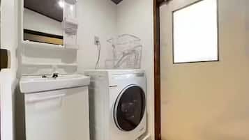 A compact laundry room with a washing machine and a dryer.