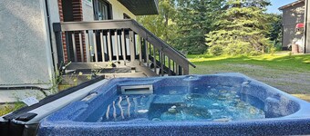 Spacious 6-bedroom Swiss style chalet in with Hot-tub for 14 people .