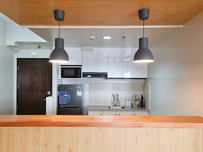 Fridge, microwave, cookware/dishes/utensils, dining tables