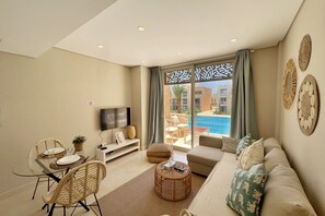 Apartment | Living area | 55-inch Smart TV with cable channels - Xuru Stays I Homestyle & Summery 1bdr@ Mangroovy Free Beach Pool (El Gouna)