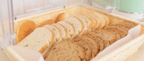 A basket of sliced bread in a clear plastic container.