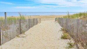 A sandy beach path leading to the ocean, flanked by wooden fences. - Oceanfront 2 Bed/2 Bath, Sleeps 8 (Ocean City)