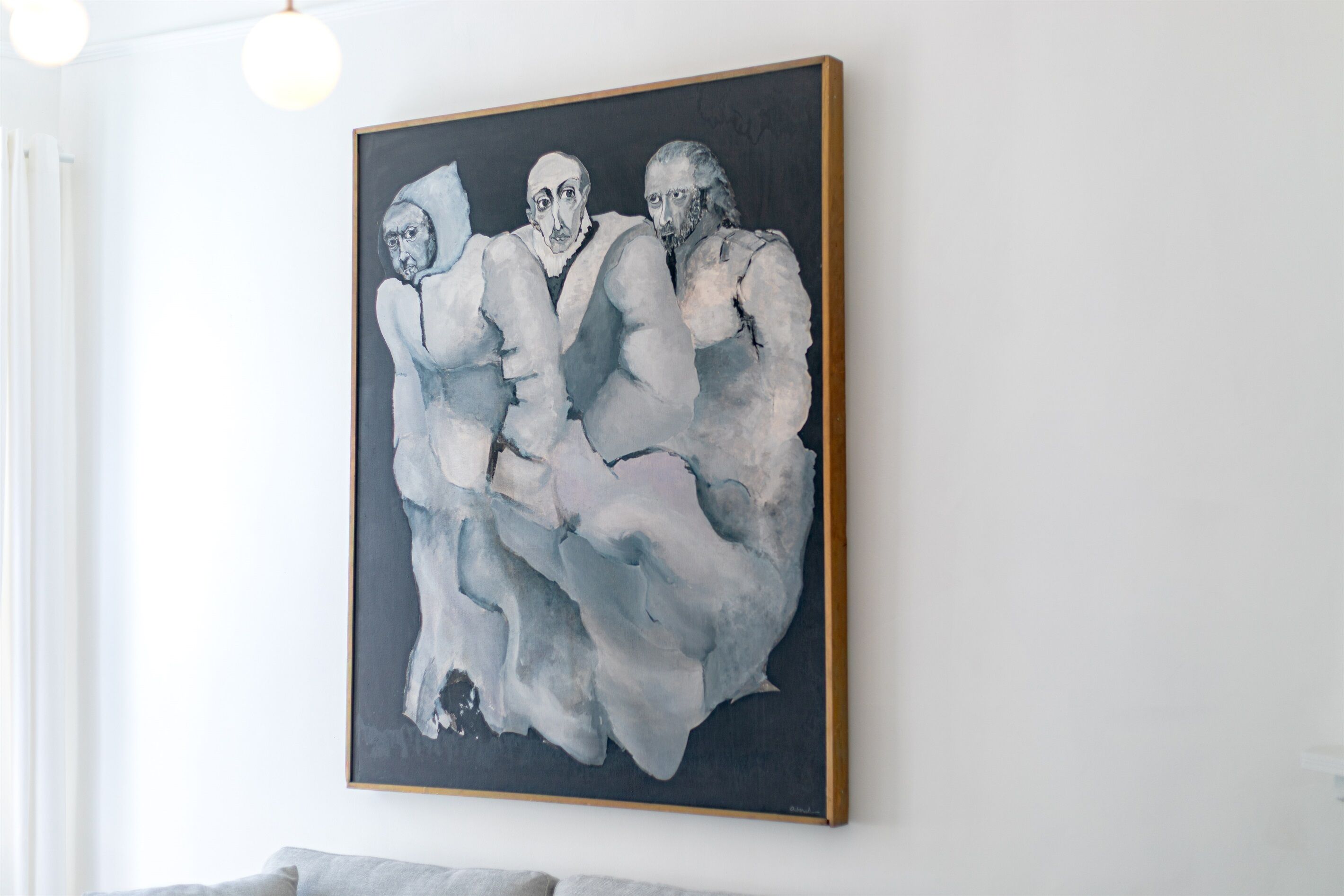 A painting of three figures on a wall.