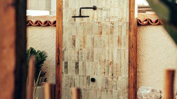 Shower, hair dryer, slippers, towels