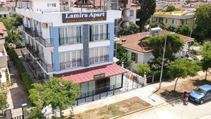 A multi-story building with a sign reading "Lamira Apart" indicating a guest house. - Lamira Pansion (Fethiye)