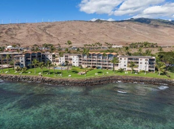 A coastal hotel with multiple balconies, a pool, and a view of the ocean. - Maalaea Kai #102 1 Bedroom Condo (Wailuku)