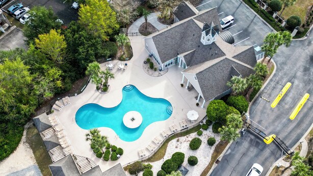 En bostadsfastighet med en swimmingpool, en täckt uteplats och en parkeringsplats.