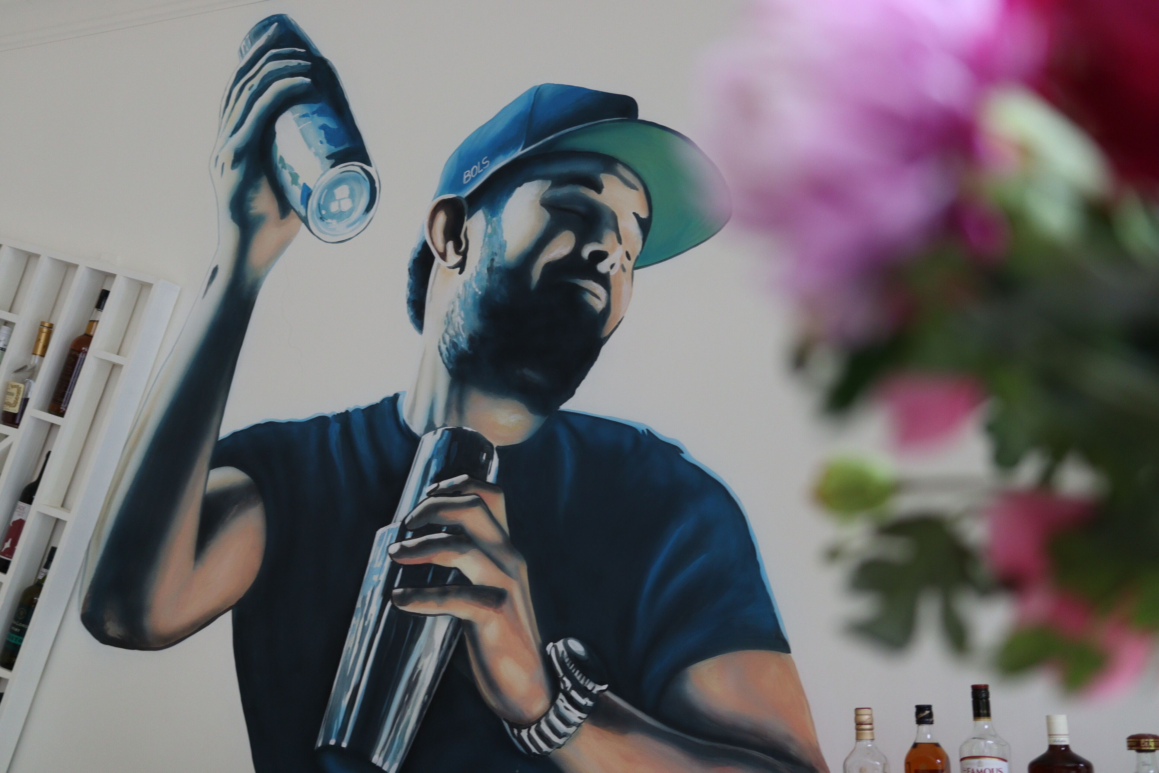 A mural of a person holding a can and a microphone.