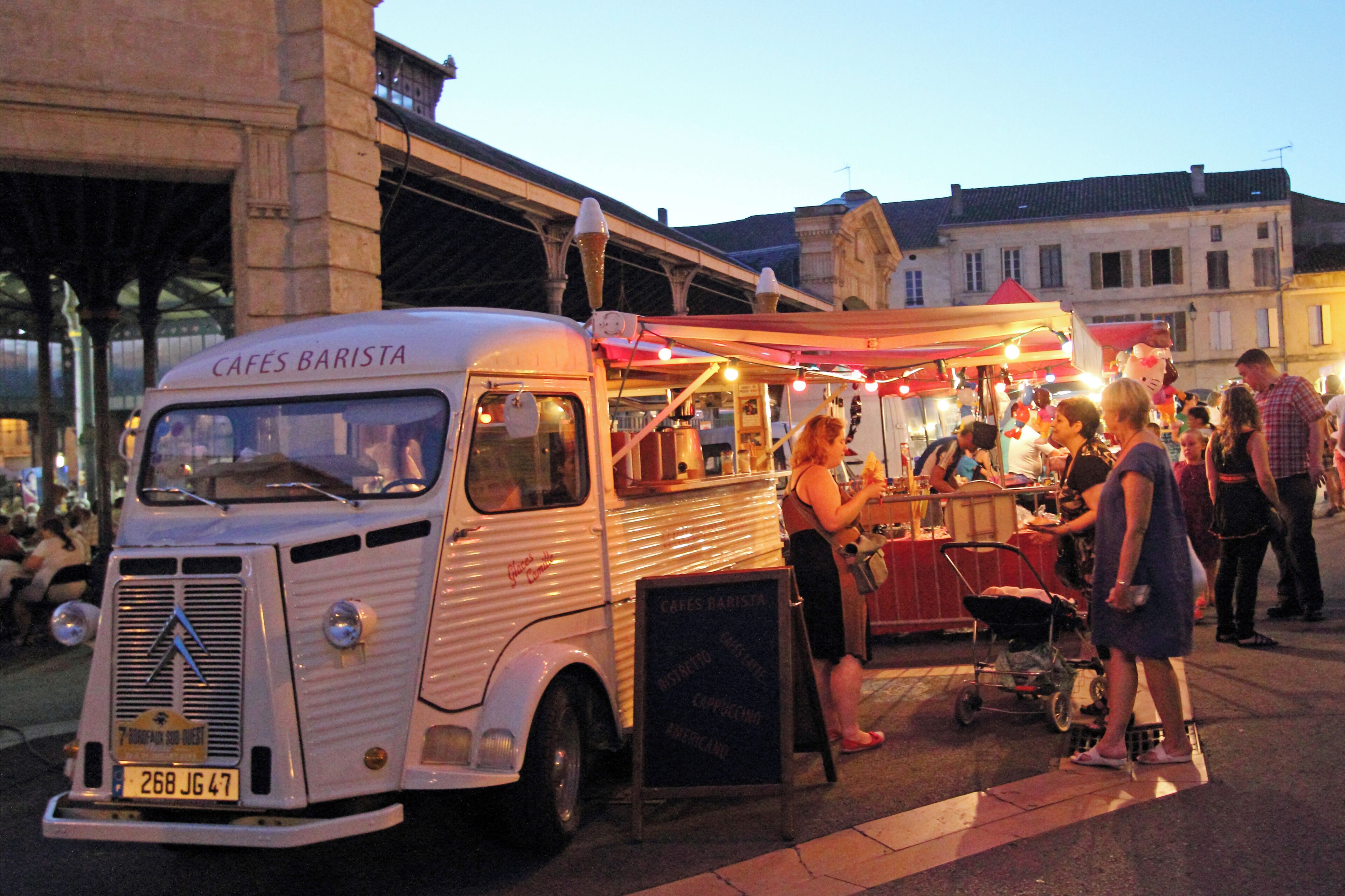 A vintage food truck with a sign reading "Cafes Barista" parked on a street.
