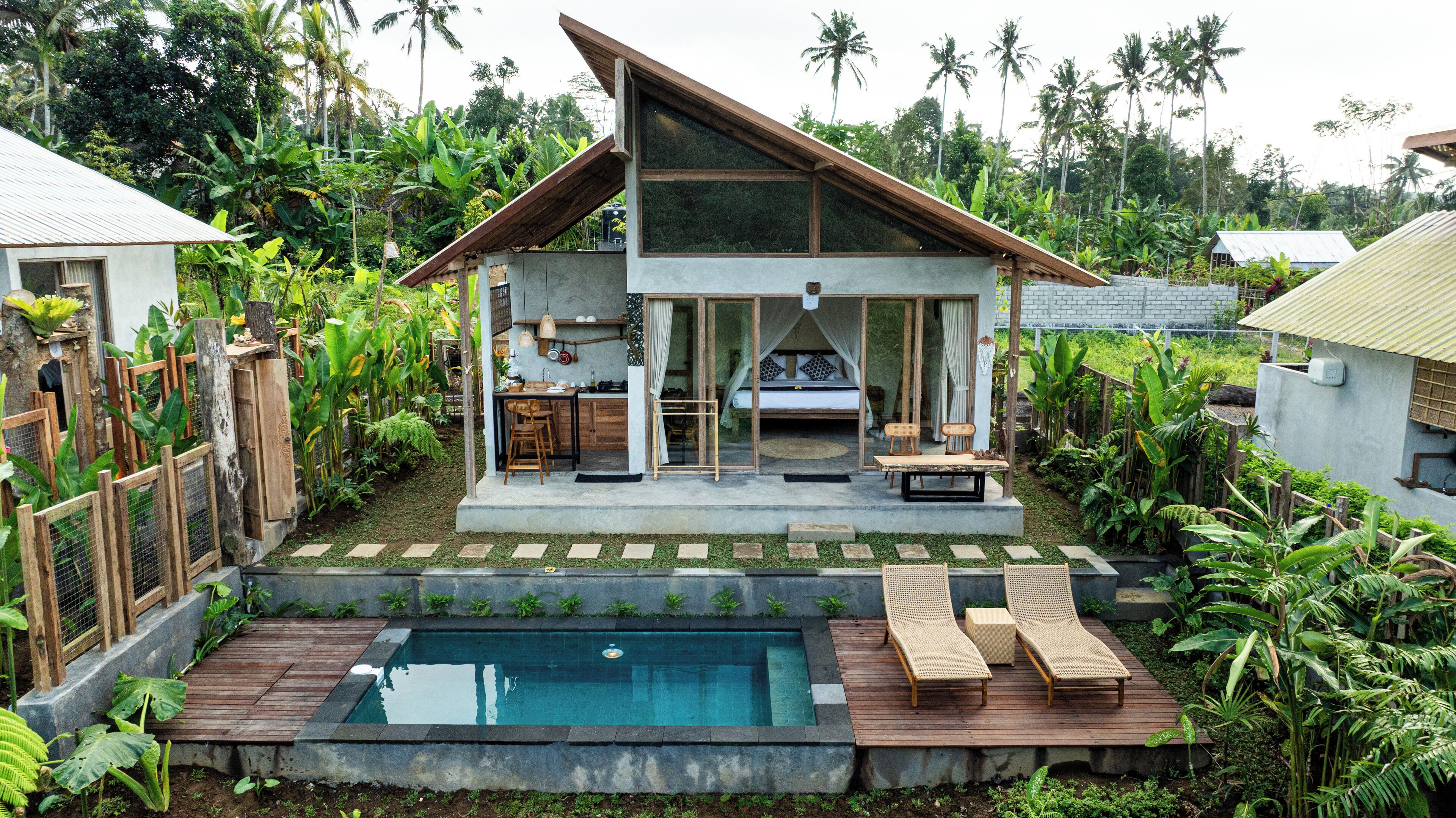 A modern house with a pool, a dining area, and a bedroom with a canopy.