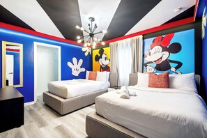 A hotel room with two beds, a Mickey Mouse mural, and a modern chandelier. - Mario, Mickey & Jedi Arcade Villa w/ Themed Rooms (Kissimmee)
