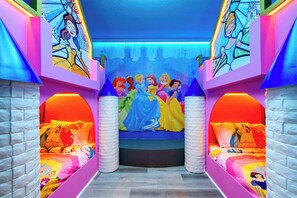 A children's room with a bed featuring Disney princesses, a mural of a castle, and a window with a view of a cityscape. - Mario, Mickey & Jedi Arcade Villa w/ Themed Rooms (Kissimmee)