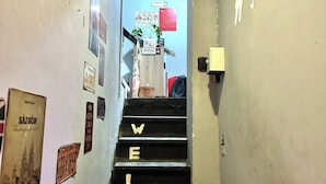 A narrow stairway with steps labeled "WELCOME" leading to a reception area. - B Homeaway Bui Vien (Ho Chi Minh City)