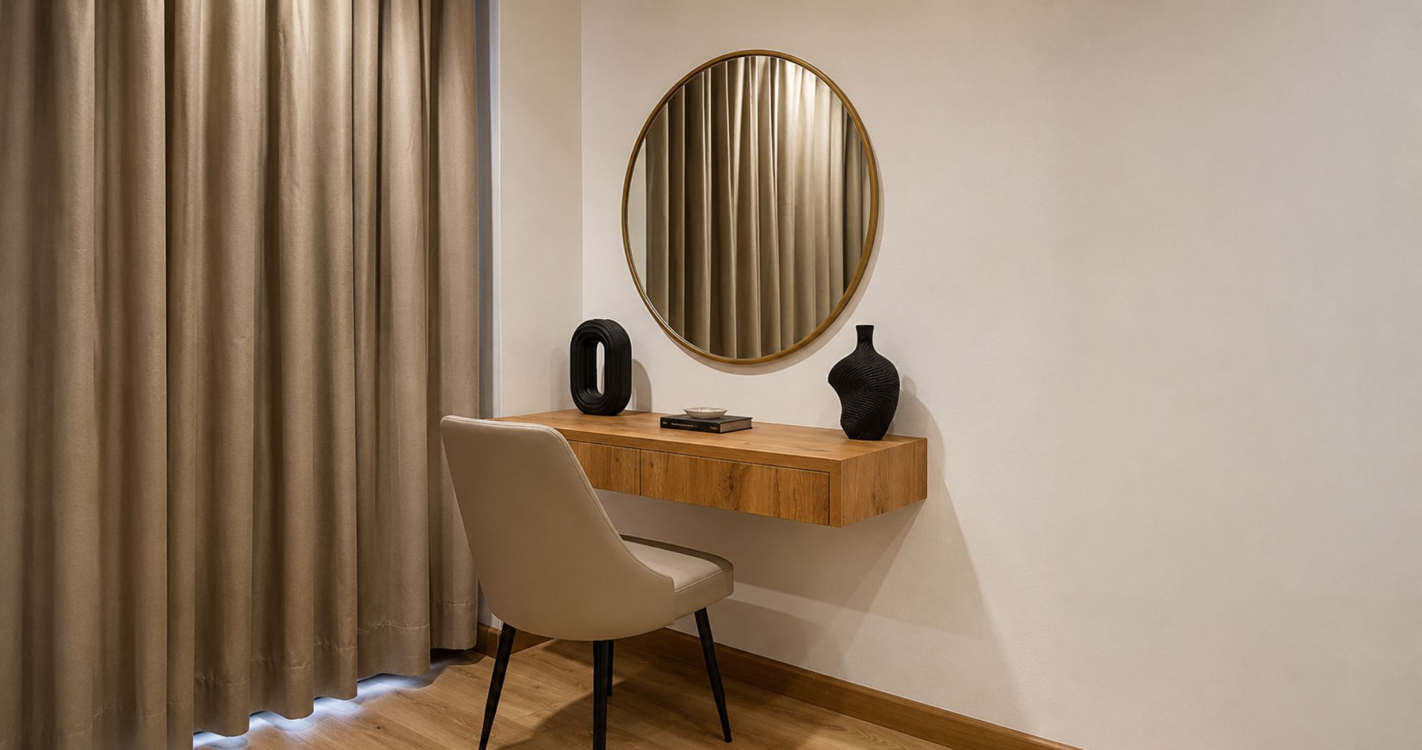 A room with a desk, chair, and a round mirror on the wall.
