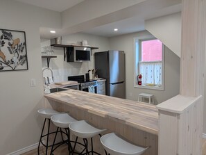 Fridge, microwave, oven, stovetop - One Main Guesthouse - Entire Home - 2 King Suites Across Two Floors -EV Charging (Prince Edward)