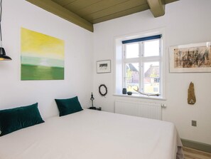 A bedroom with a bed, a window, a picture, and a lamp. - 4 Person Holiday Home in Hojer (Højer)