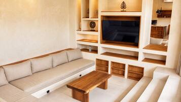 A modern living room with a sofa, a coffee table, and built-in shelves.