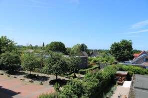 A residential area with houses, trees, and a clear sky.