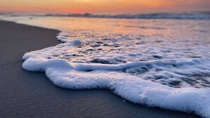A beach with waves gently lapping onto the shore. - Pirate-Themed Luxury Beach House-Free Golf Cart-Ocean Views-Ocean Lakes (Myrtle Beach)