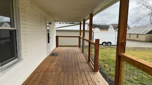 A wooden deck with a railing, a window, and a door. - Quaint Village 4 bedroom home in Friendship IN (Versailles)