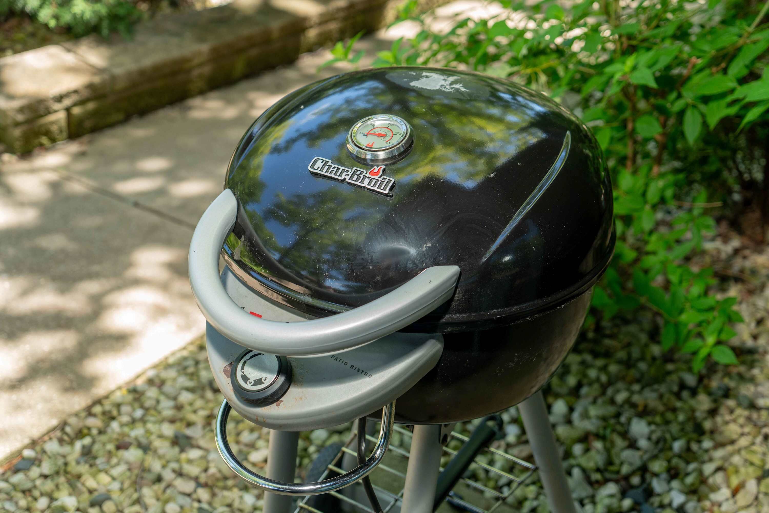 A Char-Broil gas grill with a control knob and a metal handle, set on a metal stand.