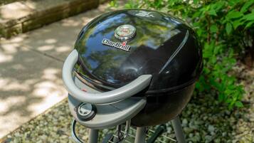 A Char-Broil gas grill with a control knob and a metal handle, set on a metal stand.