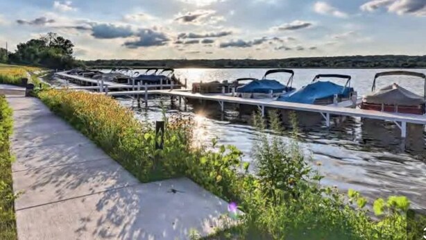 A serene lakeside setting with a dock and boats, a walking path, and a clear sky. - Cozy Condo at Interlaken! Stay & Play on Lake Como (Lake Geneva)