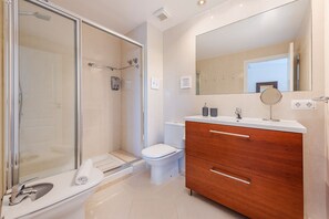 Shower, hair dryer, towels, toilet paper