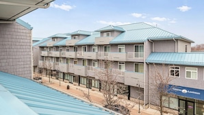 A multi-story building with a modern design, featuring balconies and large windows. - Spacious Grand Haven Getaway (Grand Haven)